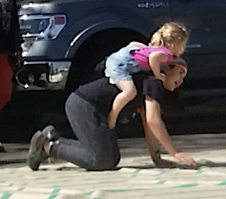 man giving piggy back to a young girl on a labyrinth